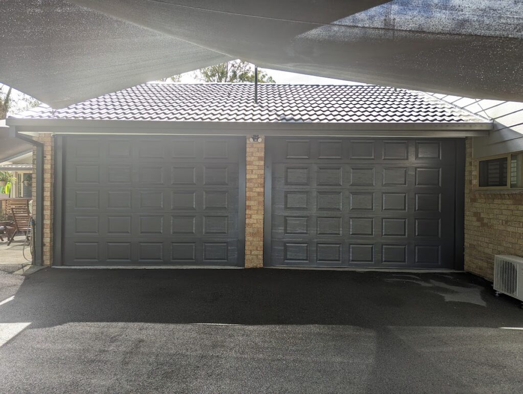 Double garage with dark panel doors