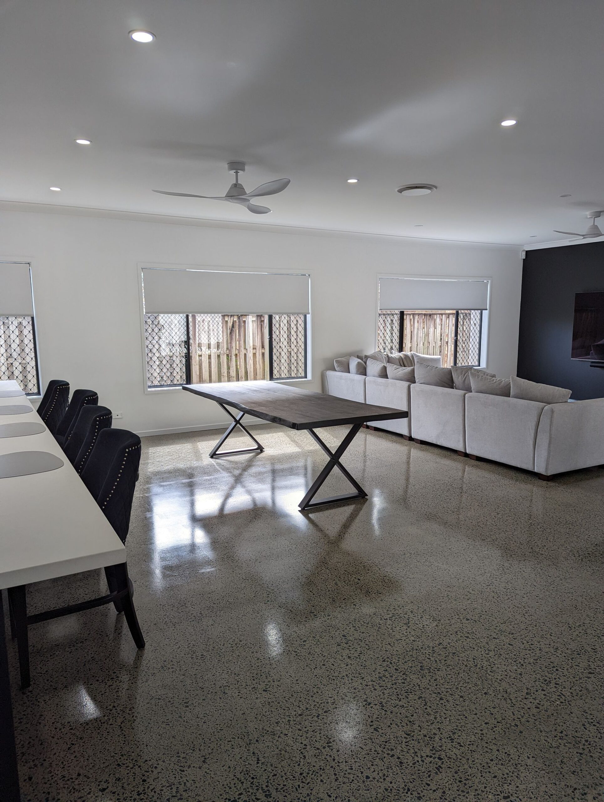 Open-plan dining and living area with polished concrete floors, Carrara