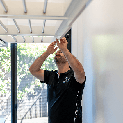Complete Homes installing a ceiling-mounted pull-down clothes airer in a renovated Gold Coast laundry