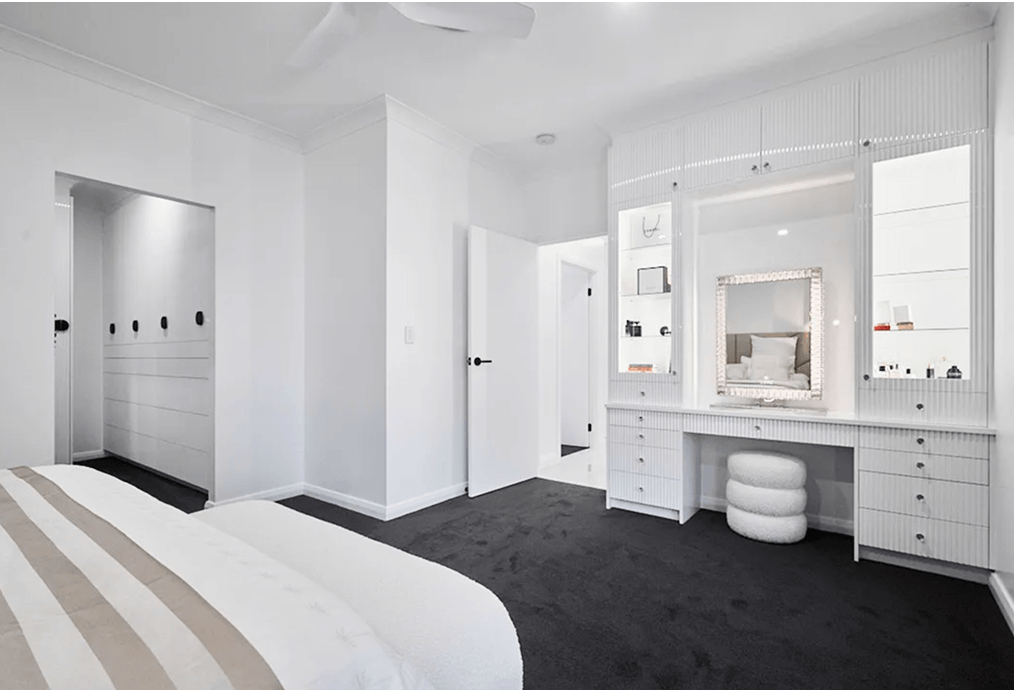 Renovated main bedroom with built-in wardrobes and a fitted dressing table