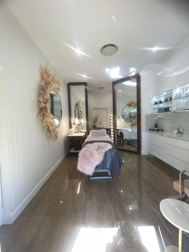 Salon treatment room with timber-look flooring and full-height mirrors, Varsity Lakes