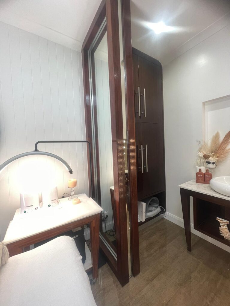 Salon treatment area with a timber-framed mirror and basin, Varsity Lakes