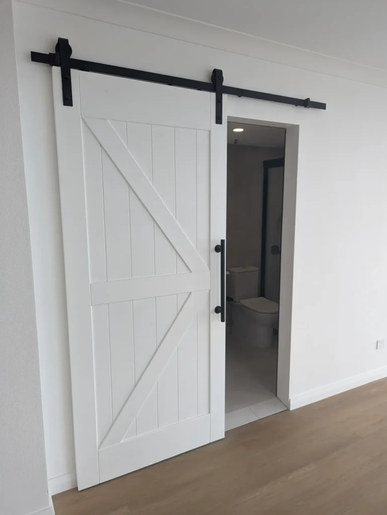 White barn-style sliding door to the renovated bathroom, Surfers Paradise apartment