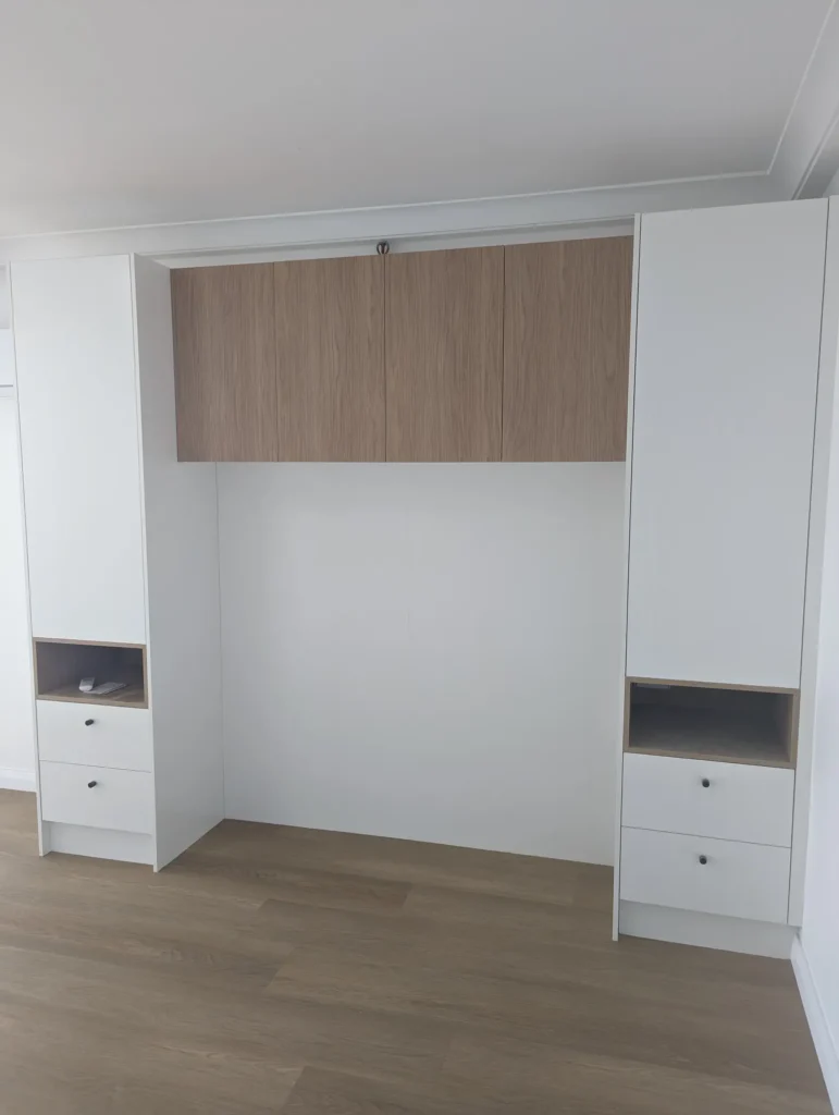 Built-in bedroom joinery with a timber headboard panel and drawers, Surfers Paradise apartment