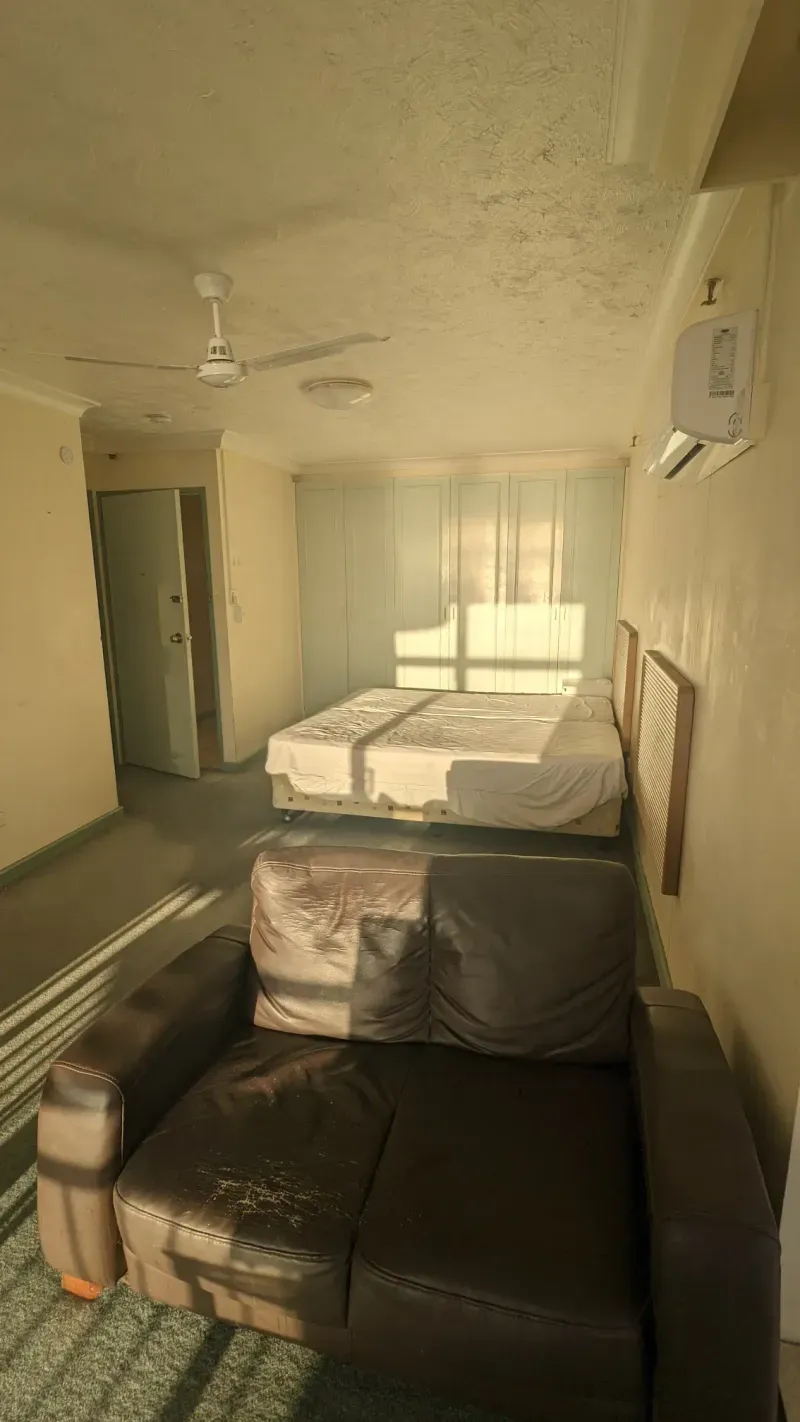 Before renovation: the original apartment bedroom with dated finishes, Surfers Paradise