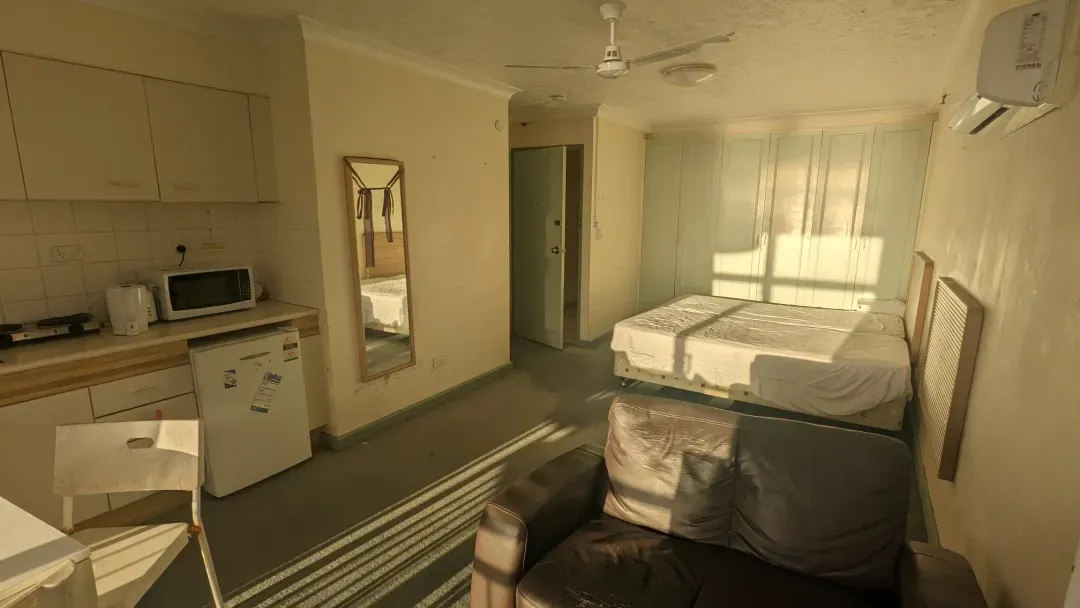 Before renovation: the original apartment studio room with a kitchenette, Surfers Paradise