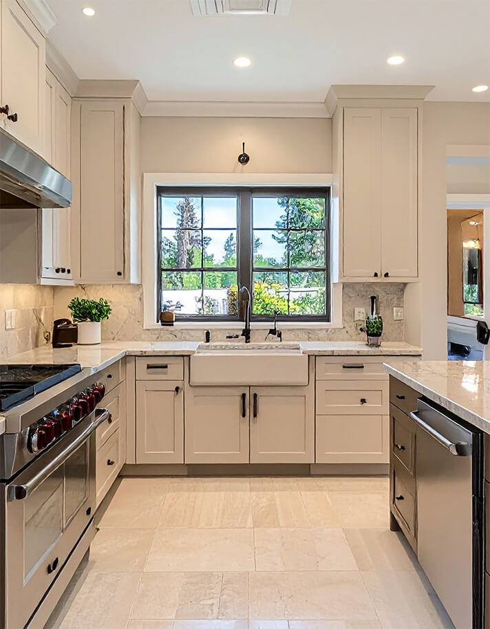 Shaker-style kitchen with a farmhouse sink and a window above the bench