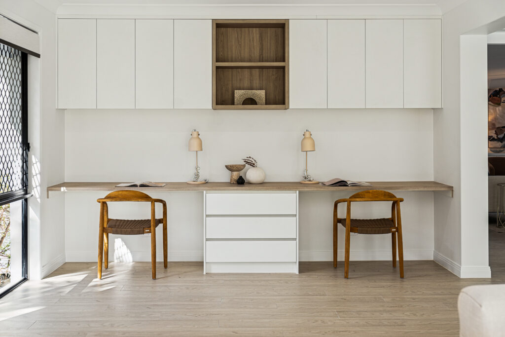 Built-in study nook with white joinery, timber benchtop and two timber chairs, Robina renovation