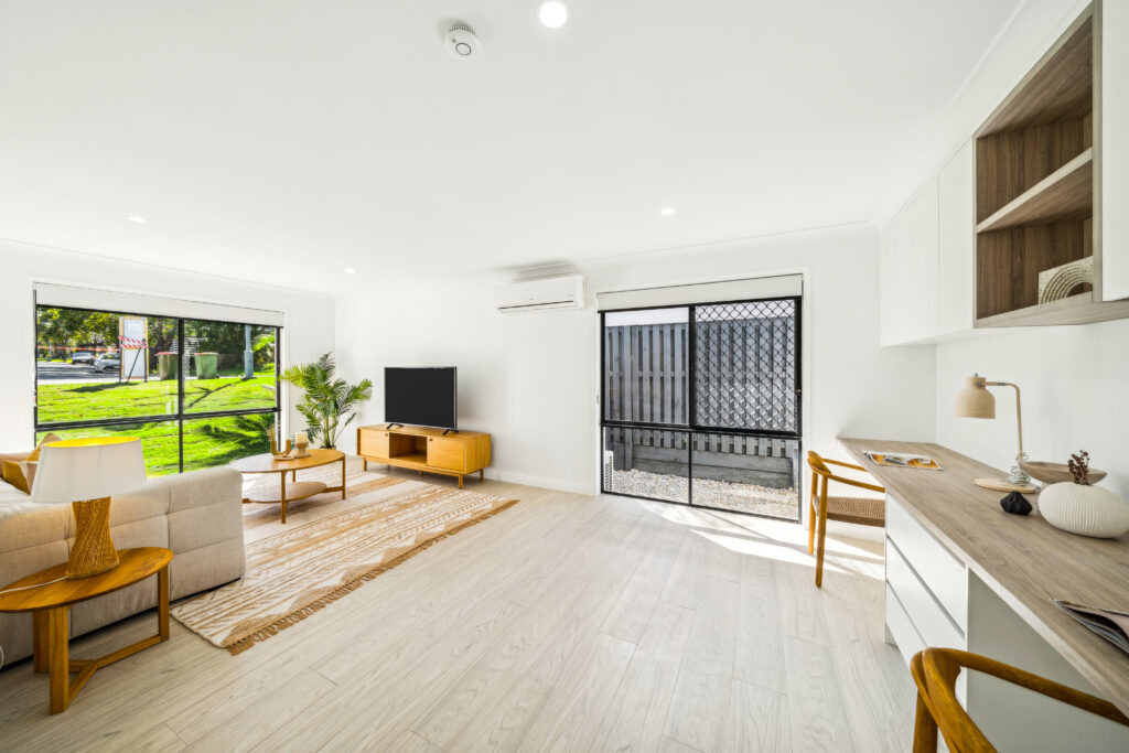 Renovated living room with sliding doors to the garden and a built-in desk along the wall, Robina