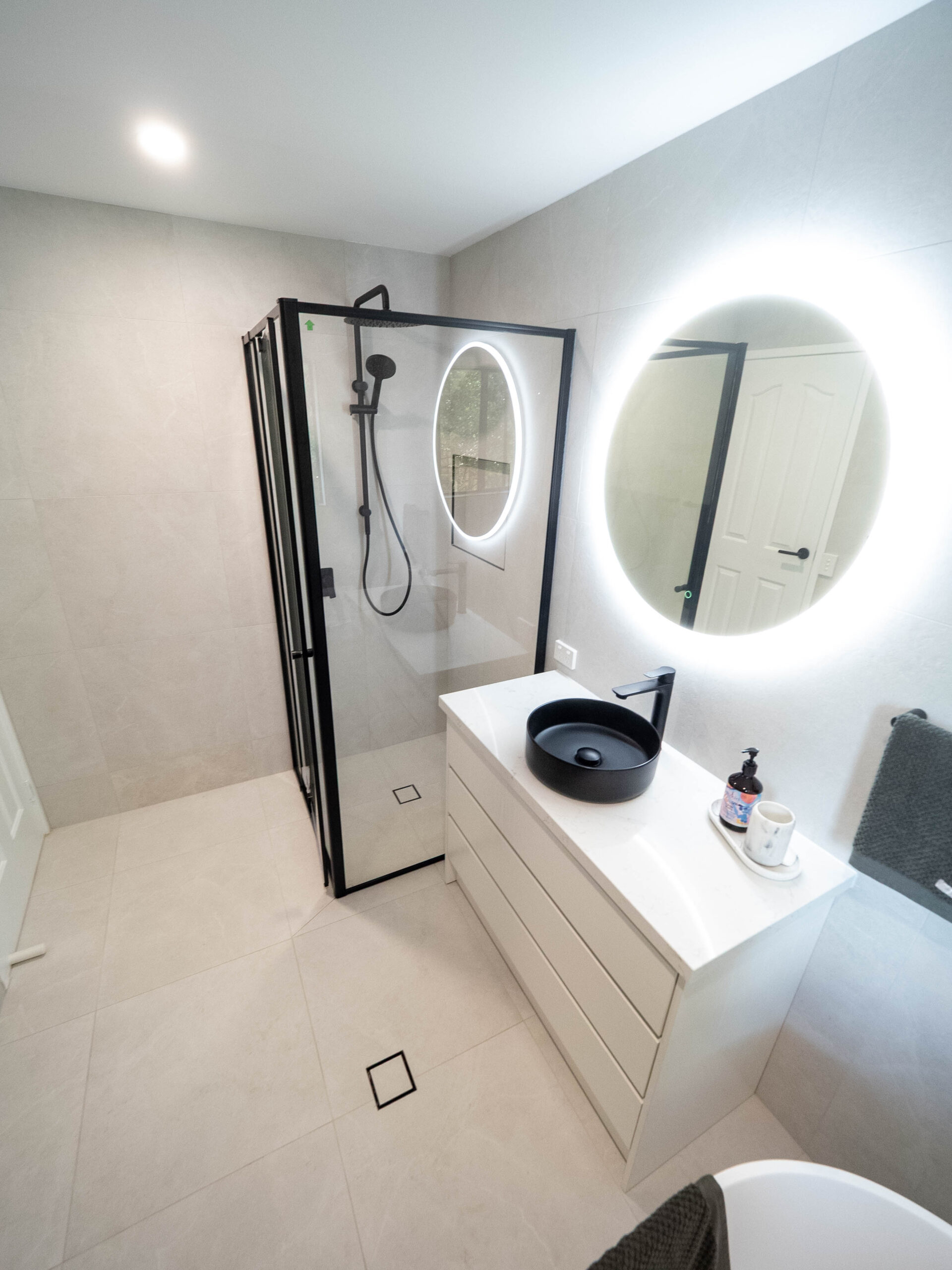 Renovated bathroom showing the walk-in shower, backlit mirror and vanity, Lower Beechmont