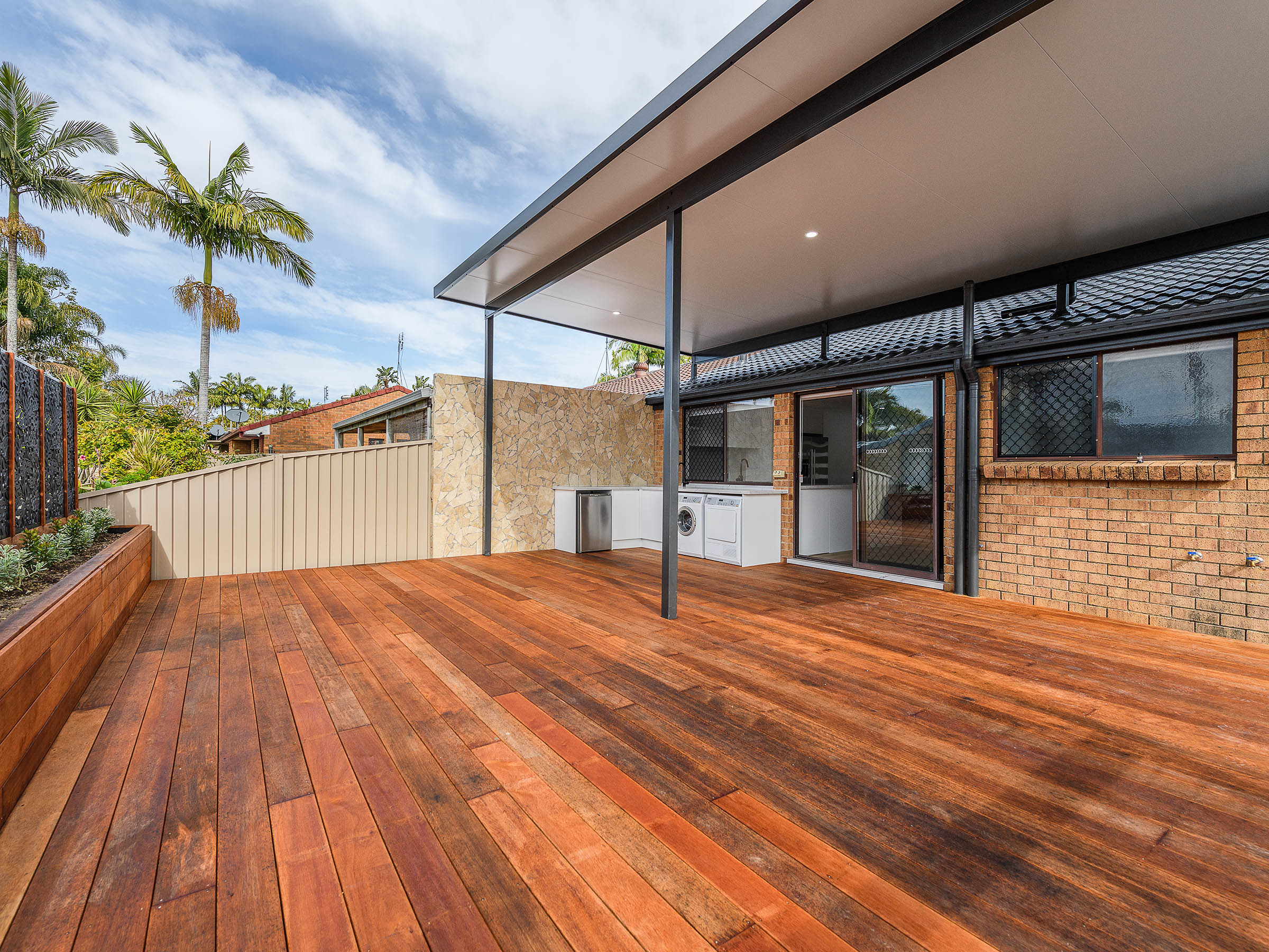 Covered timber deck and outdoor living area built by Complete Homes