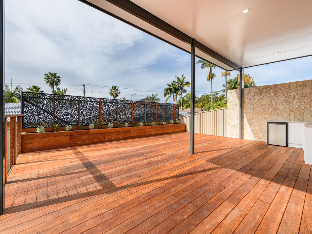 Covered hardwood deck with a built-in planter and decorative screen, Arundel