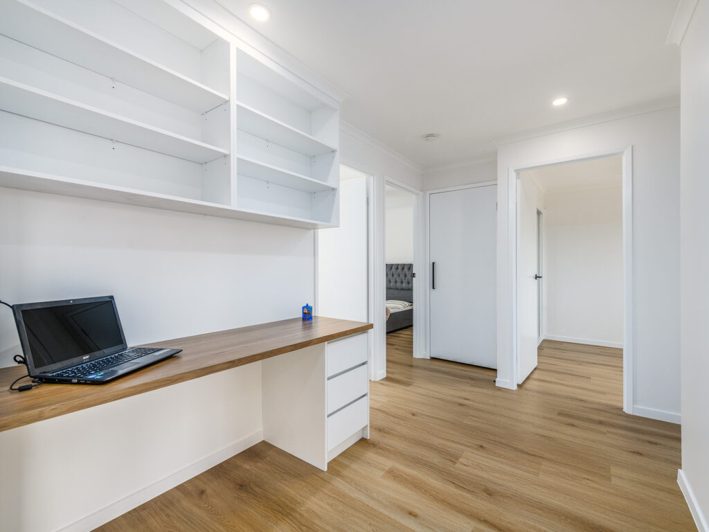 Built-in study desk with open shelving in the hallway, Arundel