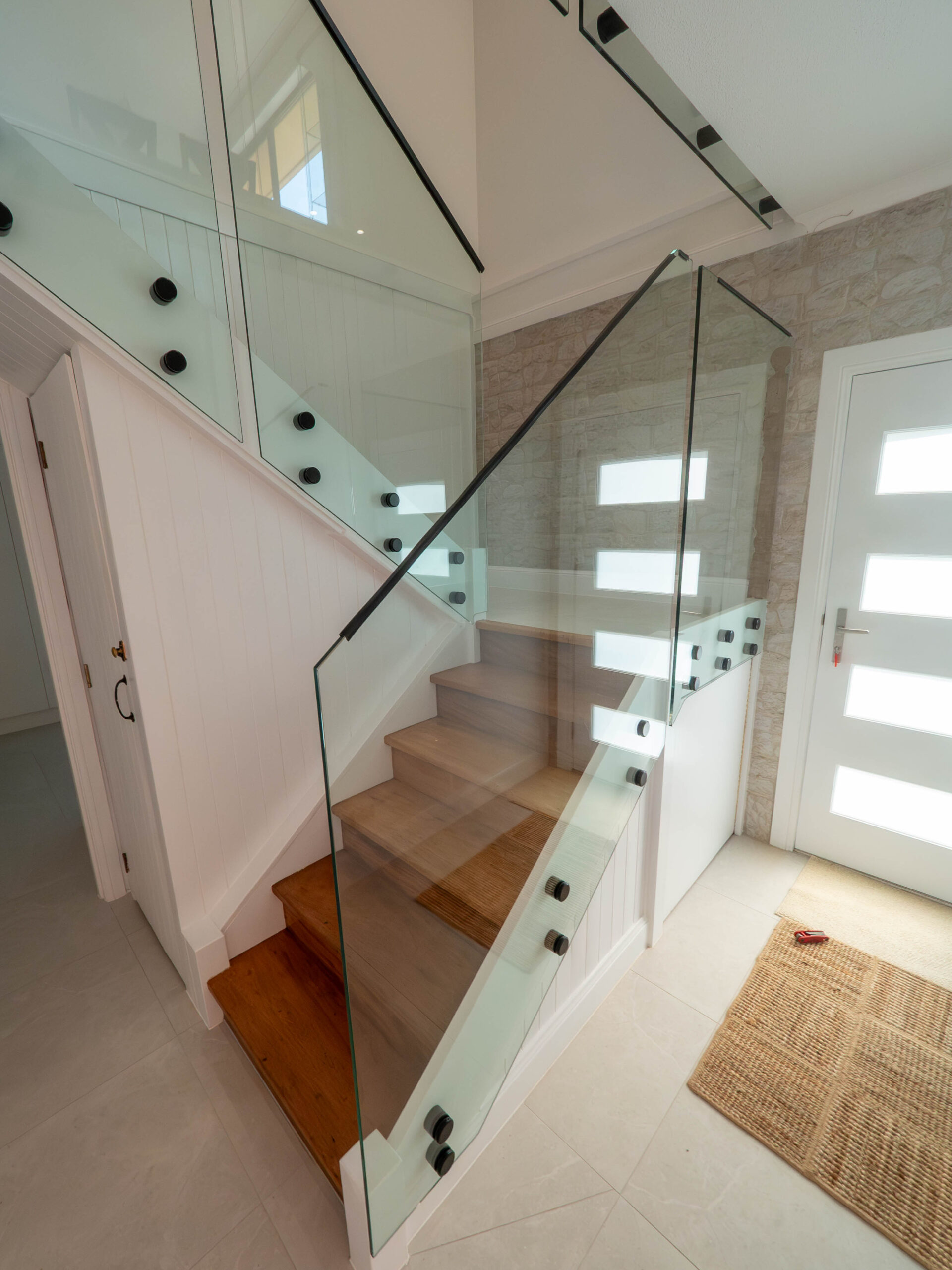 Renovated staircase with a glass balustrade and timber treads, Lower Beechmont
