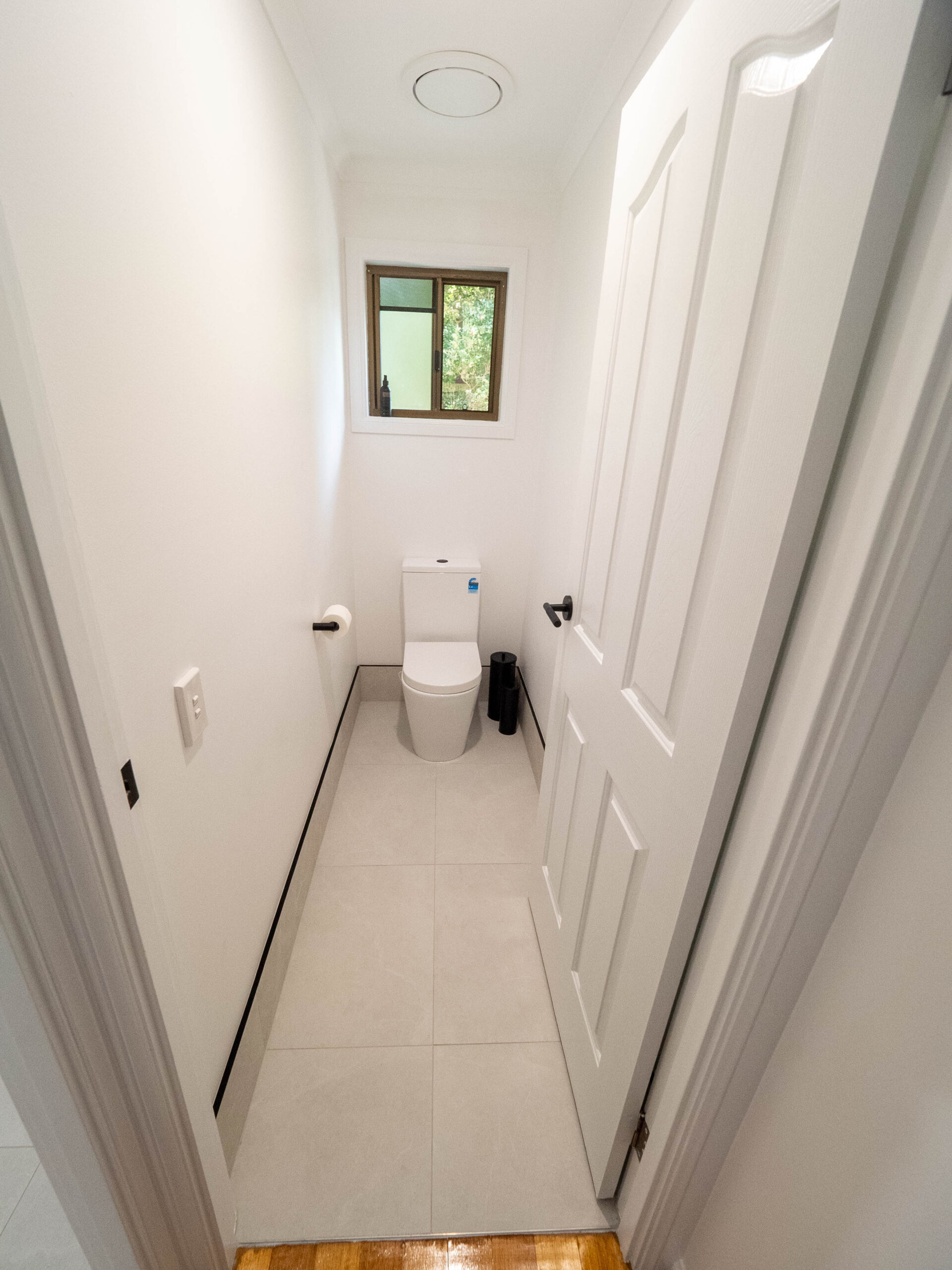 Renovated separate toilet with large-format floor tiles, Lower Beechmont